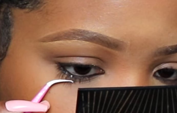 Lower Lash Extension: Step 2, pull up the upper lashes so that they don’t interfere with the lower lashes
